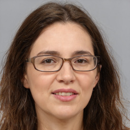 Joyful white adult female with long  brown hair and brown eyes