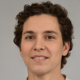 Joyful white young-adult male with medium  brown hair and brown eyes