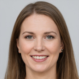 Joyful white young-adult female with long  brown hair and grey eyes