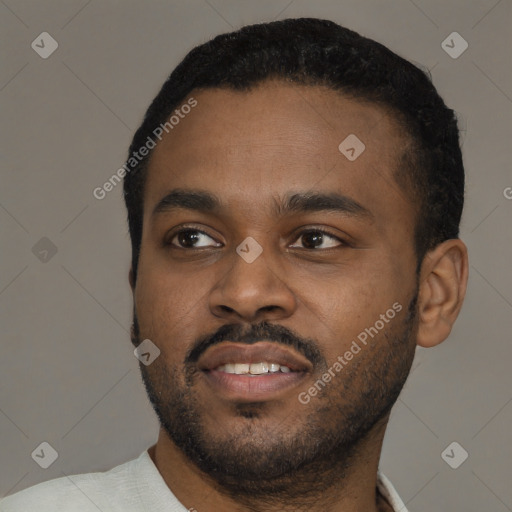 Joyful black young-adult male with short  black hair and brown eyes