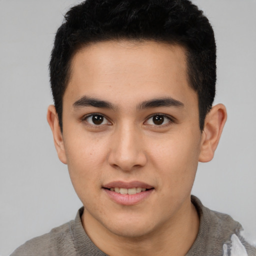 Joyful latino young-adult male with short  brown hair and brown eyes