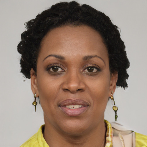 Joyful black adult female with short  brown hair and brown eyes