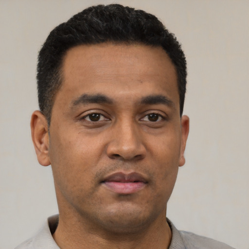 Neutral latino young-adult male with short  black hair and brown eyes