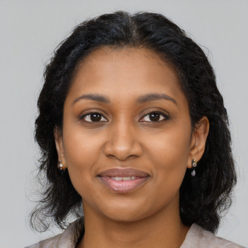 Joyful black young-adult female with medium  black hair and brown eyes