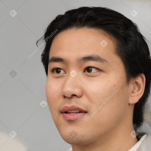 Joyful asian young-adult male with short  black hair and brown eyes