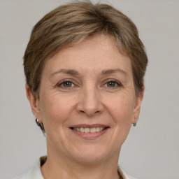 Joyful white adult female with short  brown hair and grey eyes