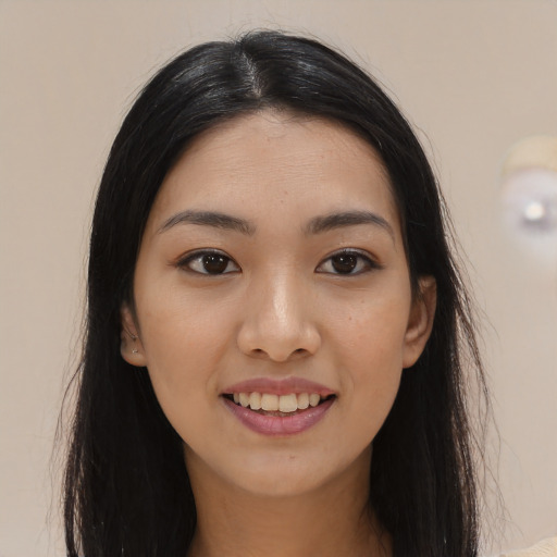 Joyful latino young-adult female with long  black hair and brown eyes