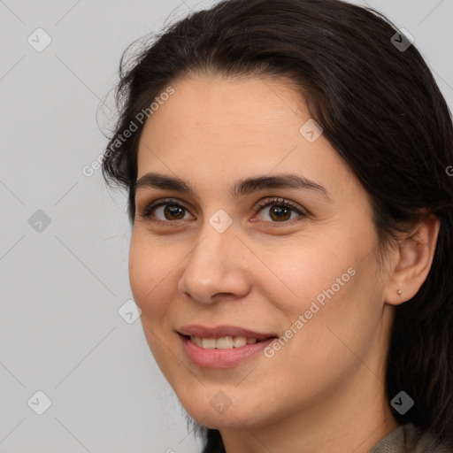 Joyful white young-adult female with long  brown hair and brown eyes