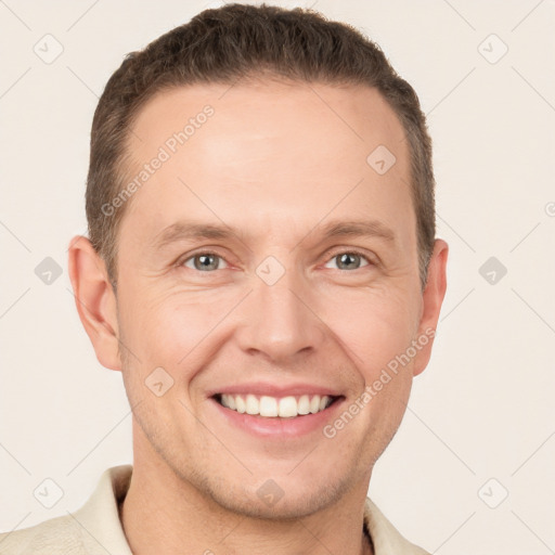 Joyful white adult male with short  brown hair and grey eyes