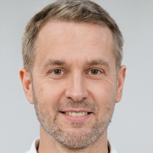 Joyful white adult male with short  brown hair and brown eyes