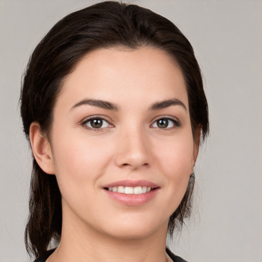 Joyful white young-adult female with medium  brown hair and brown eyes