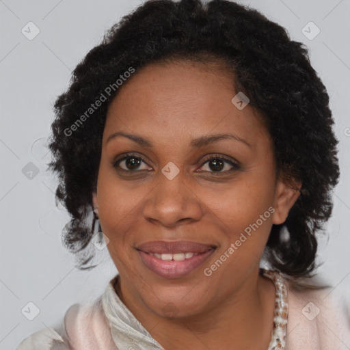 Joyful black adult female with medium  brown hair and brown eyes