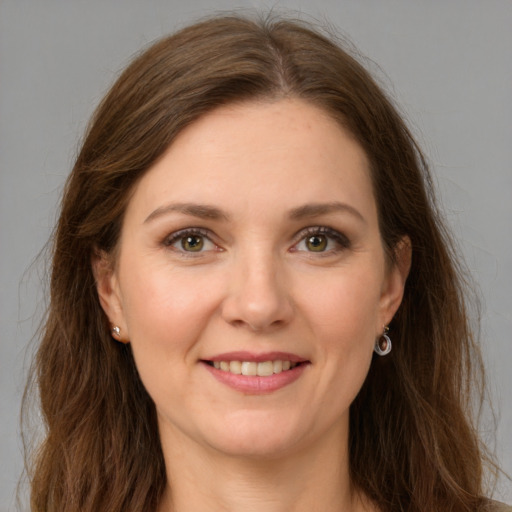 Joyful white young-adult female with long  brown hair and green eyes