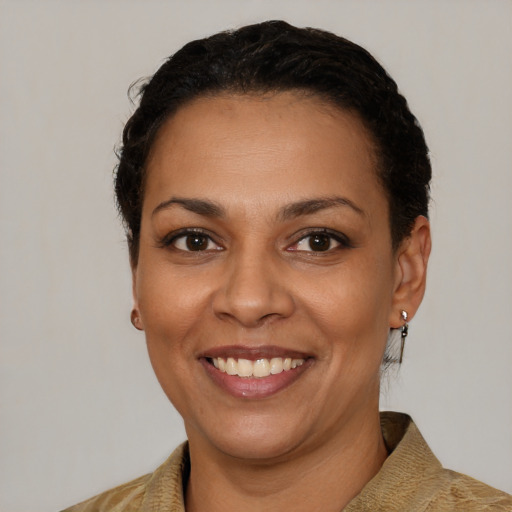 Joyful latino young-adult female with short  brown hair and brown eyes