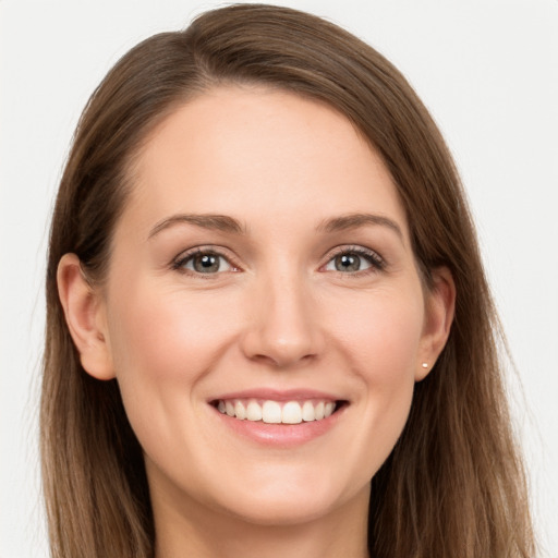 Joyful white young-adult female with long  brown hair and grey eyes