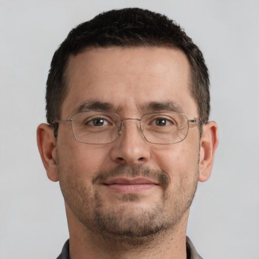 Joyful white adult male with short  brown hair and brown eyes