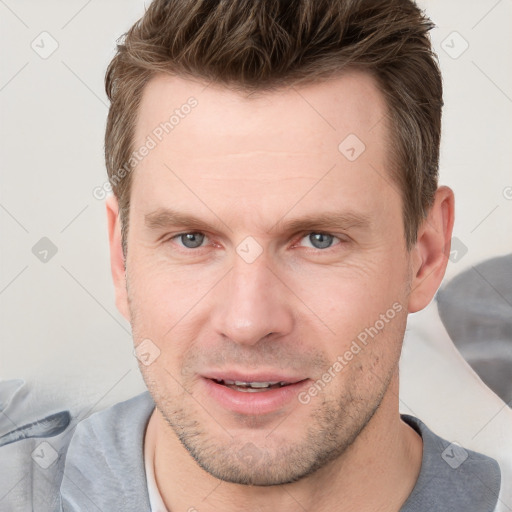 Joyful white adult male with short  brown hair and grey eyes