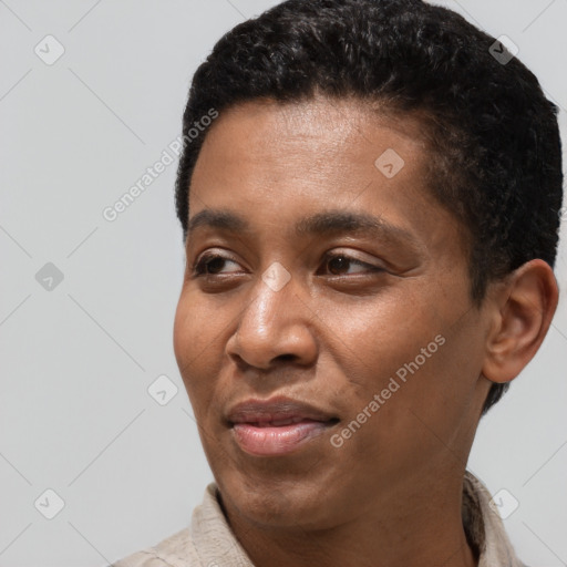 Joyful black young-adult male with short  black hair and brown eyes