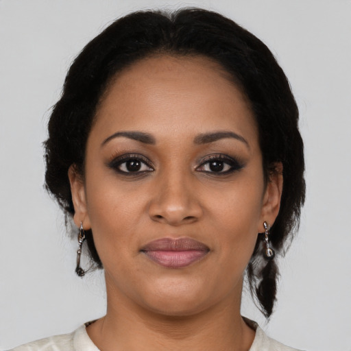 Joyful black young-adult female with medium  black hair and brown eyes