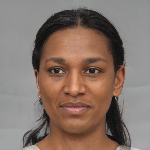 Joyful black young-adult female with medium  black hair and brown eyes
