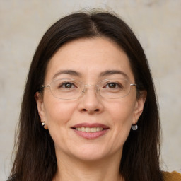 Joyful white adult female with long  brown hair and brown eyes