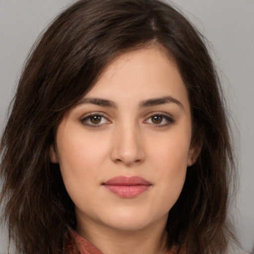 Joyful white young-adult female with long  brown hair and brown eyes