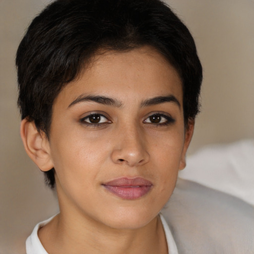 Joyful latino young-adult female with short  brown hair and brown eyes