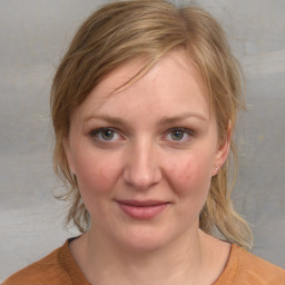 Joyful white young-adult female with medium  brown hair and blue eyes