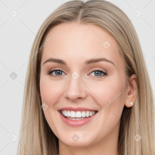 Joyful white young-adult female with long  brown hair and blue eyes