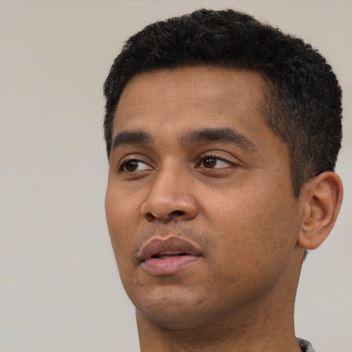 Neutral black young-adult male with short  black hair and brown eyes
