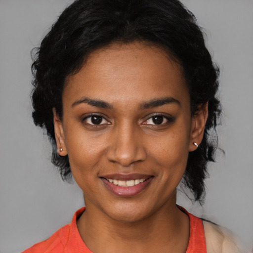 Joyful black young-adult female with medium  black hair and brown eyes