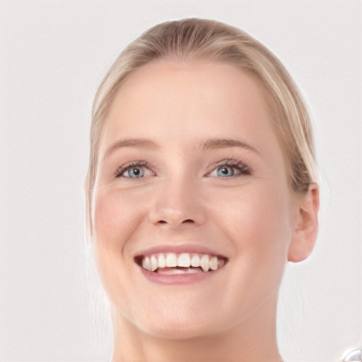 Joyful white young-adult female with medium  brown hair and blue eyes