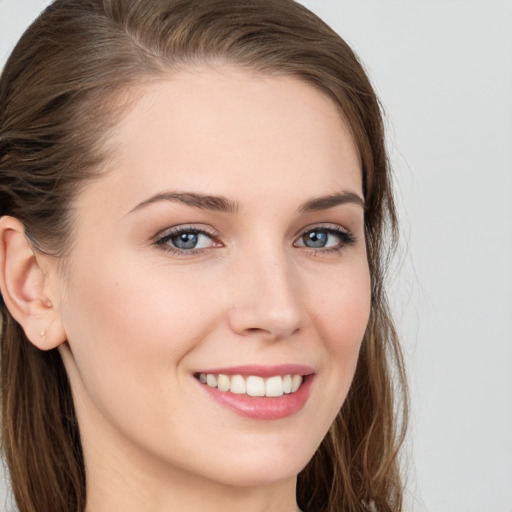 Joyful white young-adult female with long  brown hair and grey eyes