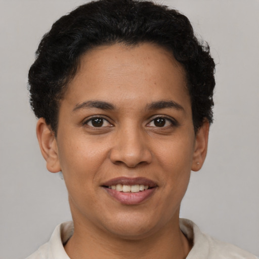 Joyful latino young-adult female with short  brown hair and brown eyes