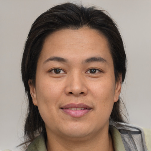 Joyful asian adult female with medium  brown hair and brown eyes
