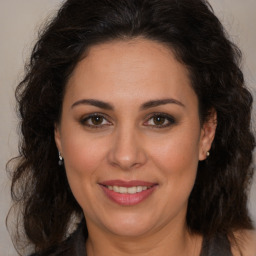 Joyful white adult female with long  brown hair and brown eyes