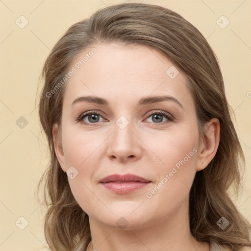 Joyful white young-adult female with long  brown hair and grey eyes