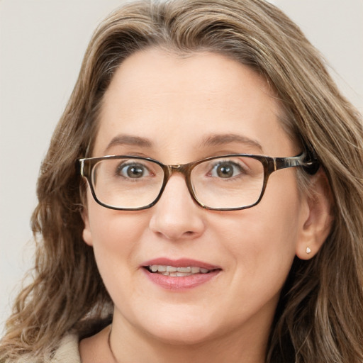 Joyful white adult female with long  brown hair and blue eyes