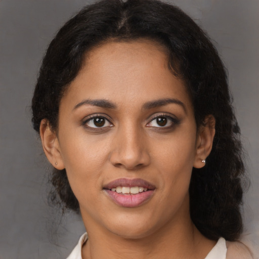 Joyful latino young-adult female with short  brown hair and brown eyes