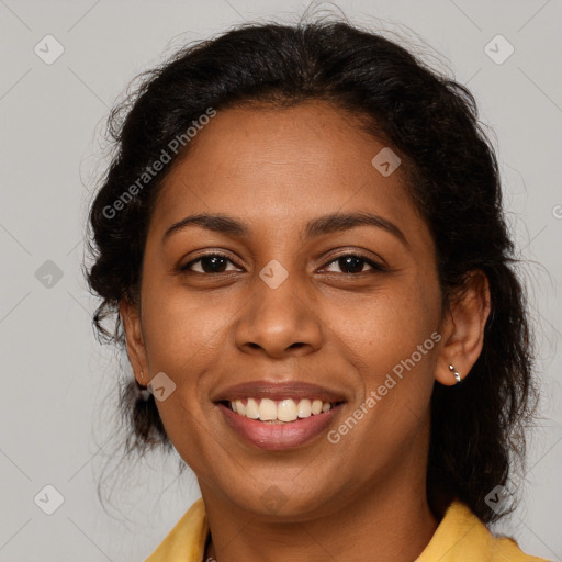 Joyful black young-adult female with long  brown hair and brown eyes