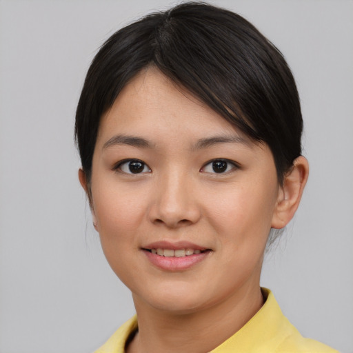 Joyful asian young-adult female with short  brown hair and brown eyes