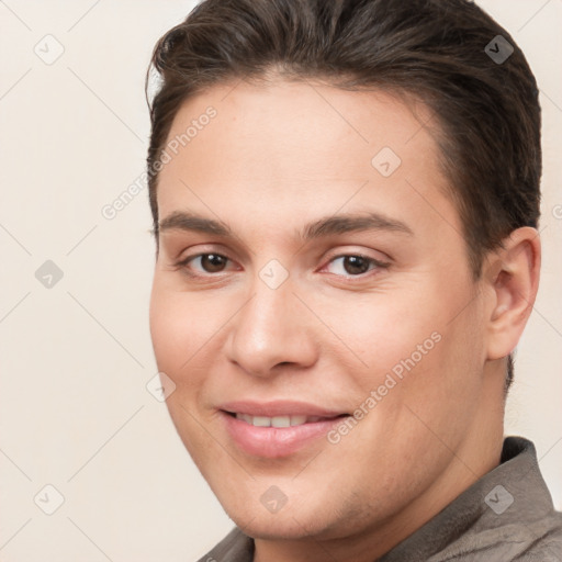 Joyful white young-adult male with short  brown hair and brown eyes