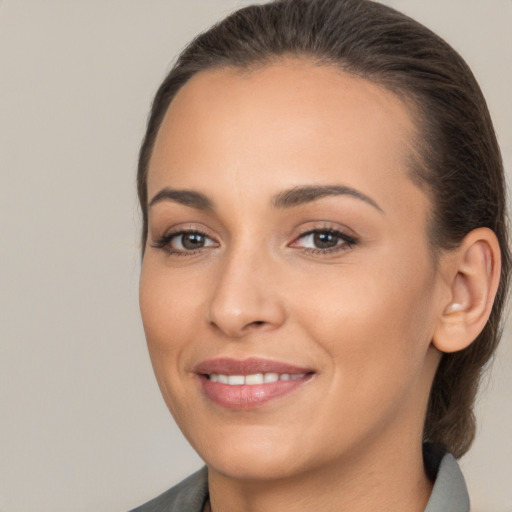 Joyful white young-adult female with medium  brown hair and brown eyes