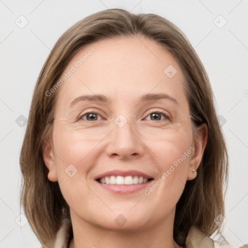 Joyful white adult female with medium  brown hair and grey eyes