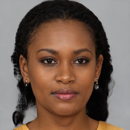 Joyful black young-adult female with medium  brown hair and brown eyes