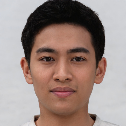 Joyful asian young-adult male with short  black hair and brown eyes