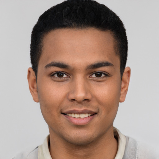 Joyful latino young-adult male with short  brown hair and brown eyes