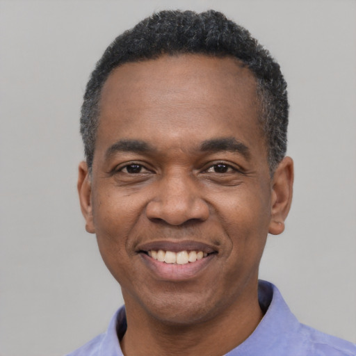 Joyful latino adult male with short  black hair and brown eyes