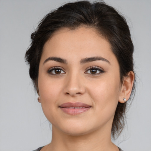 Joyful latino young-adult female with medium  brown hair and brown eyes