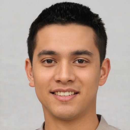 Joyful white young-adult male with short  black hair and brown eyes